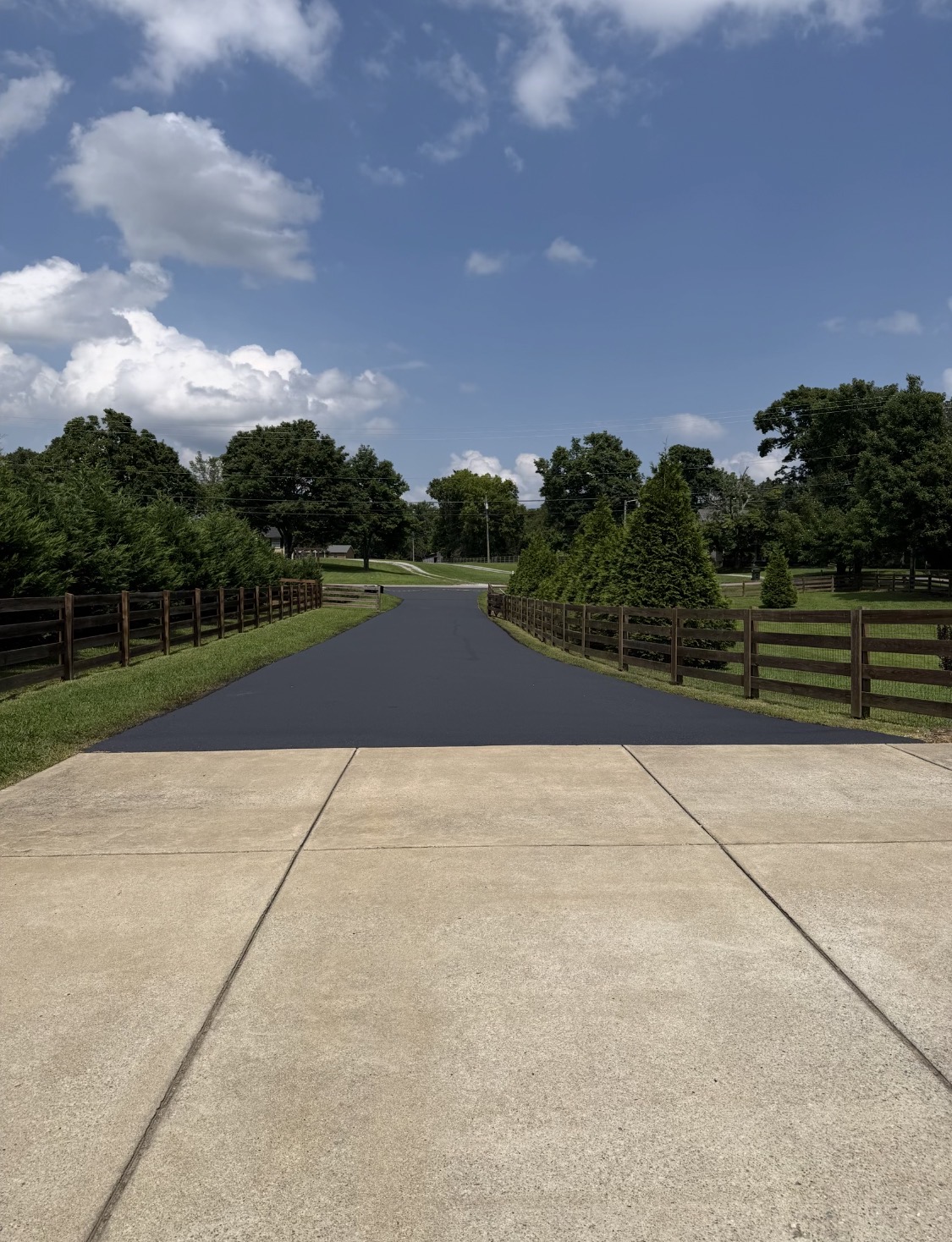 A finished gravel driveway with new fencing